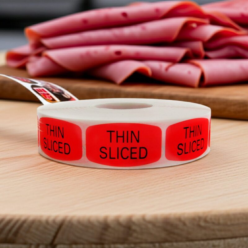Thin Sliced sticker red identification label with black print on a roll of stickers