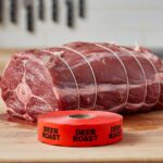 deer roast sticker on a red label with black print