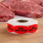 deer cube steak sticker on a red label with black print